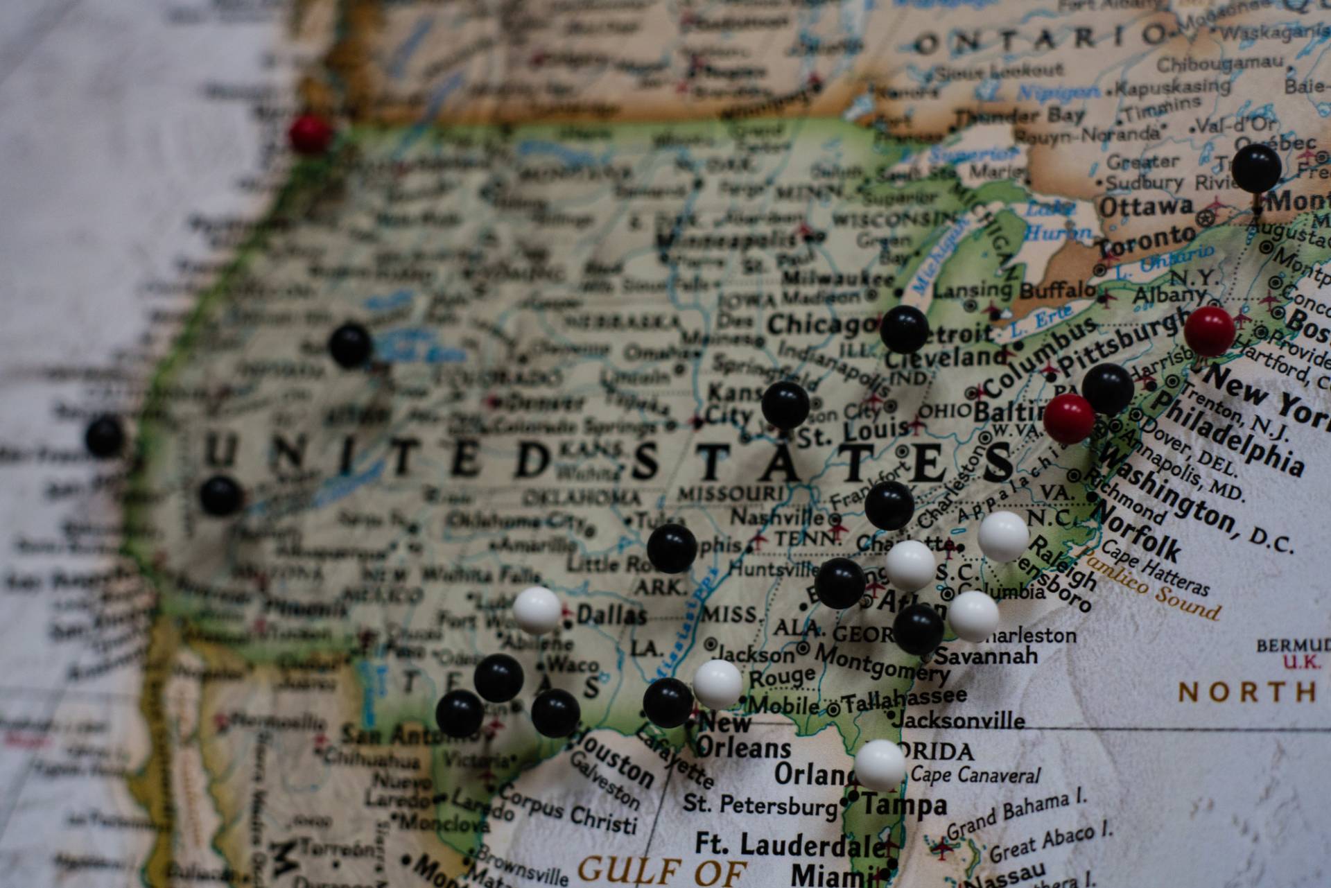 us map with pushpins in various cities.
